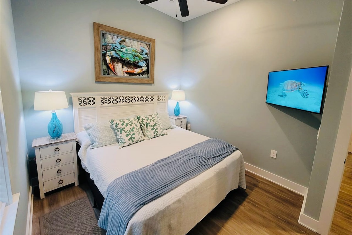 King bedroom with 4-drawer nightstands and ceiling fan. 