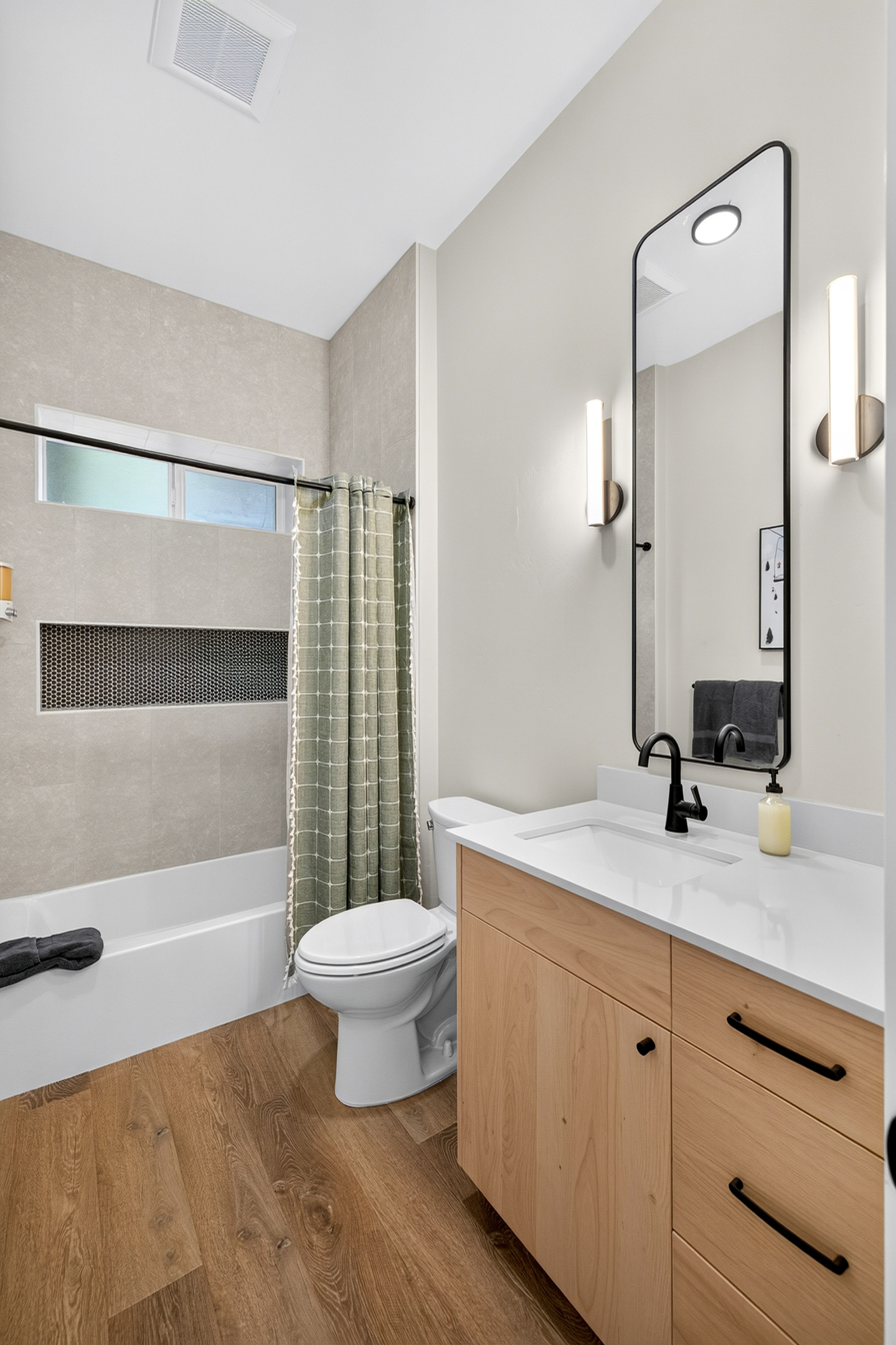 This hallway bath downstairs has all the modern comforts and serves for guests and bedrooms 1 and 2.