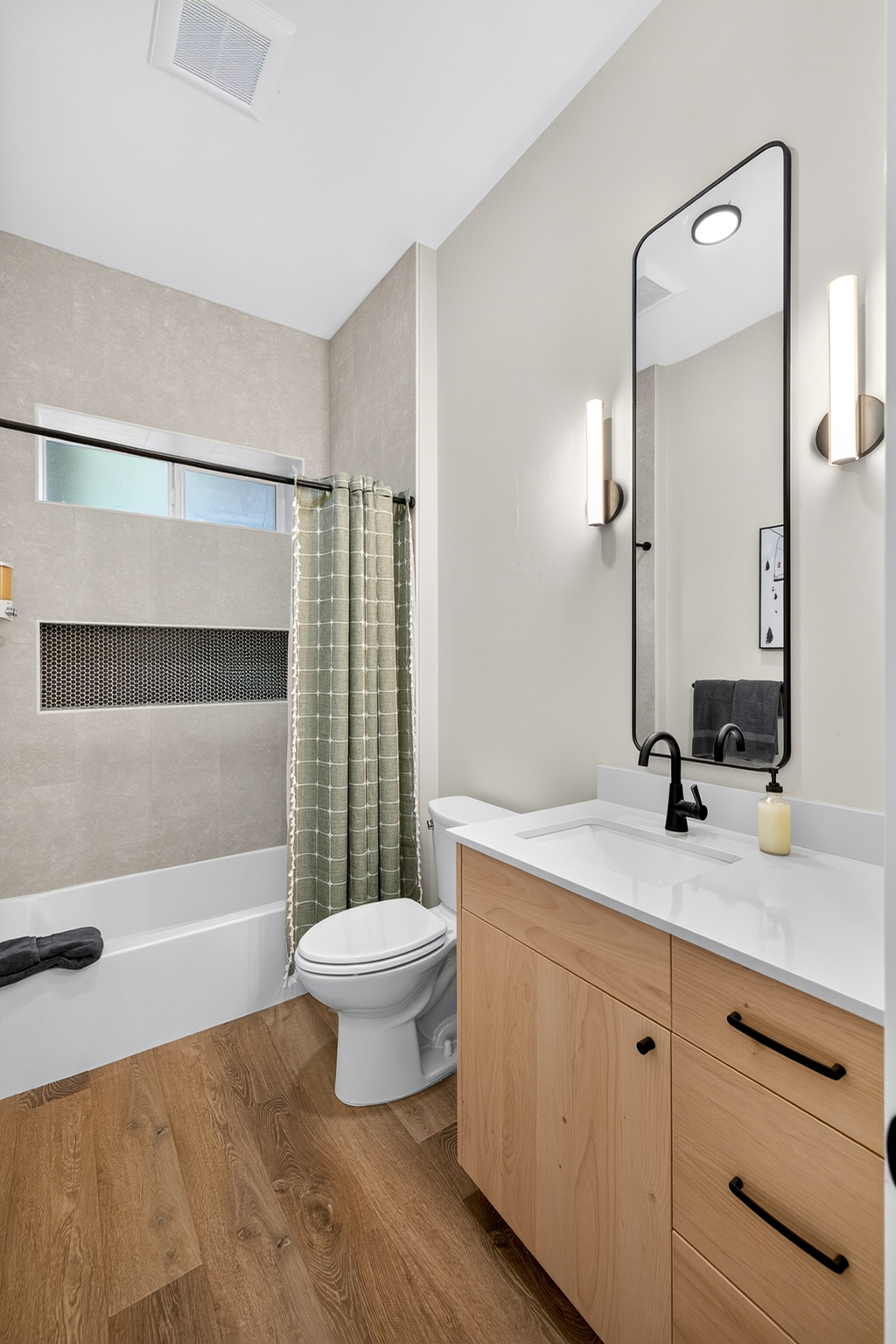 This hallway bath downstairs has all the modern comforts and serves for guests and bedrooms 1 and 2.
