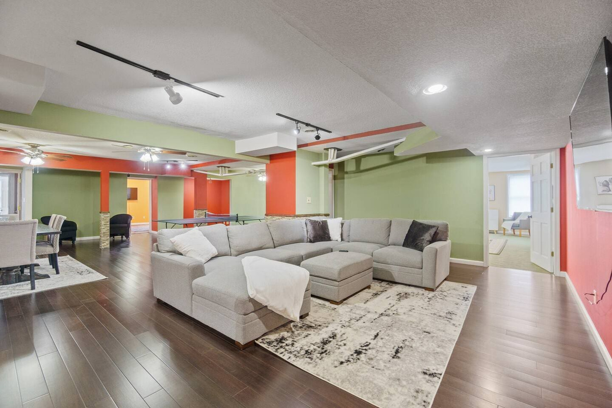 Spacious living room featuring large, comfortable couches and a soft carpet, creating a cozy and inviting space to relax and unwind.