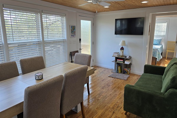 Dining, couch, TV and front entrance