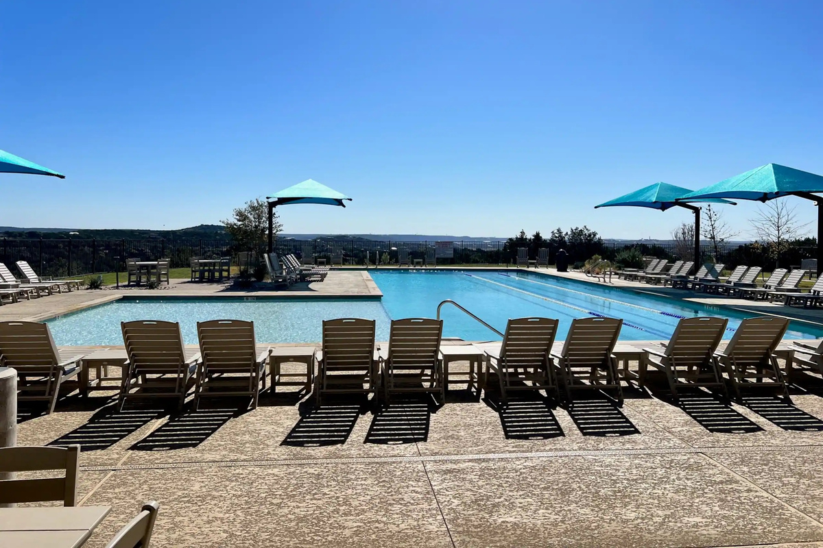 
Trailhead Club features a lap-style pool, shaded lounging, playground, basketball, and pickleball courts.