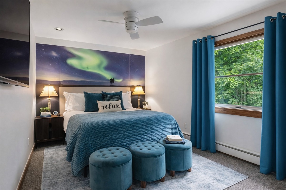 Tucked just off the Galaxy Room, this dreamy queen bedroom glows with aurora-inspired art, forest views, and a 50" HDTV—perfect for peaceful rest after a day of fun.