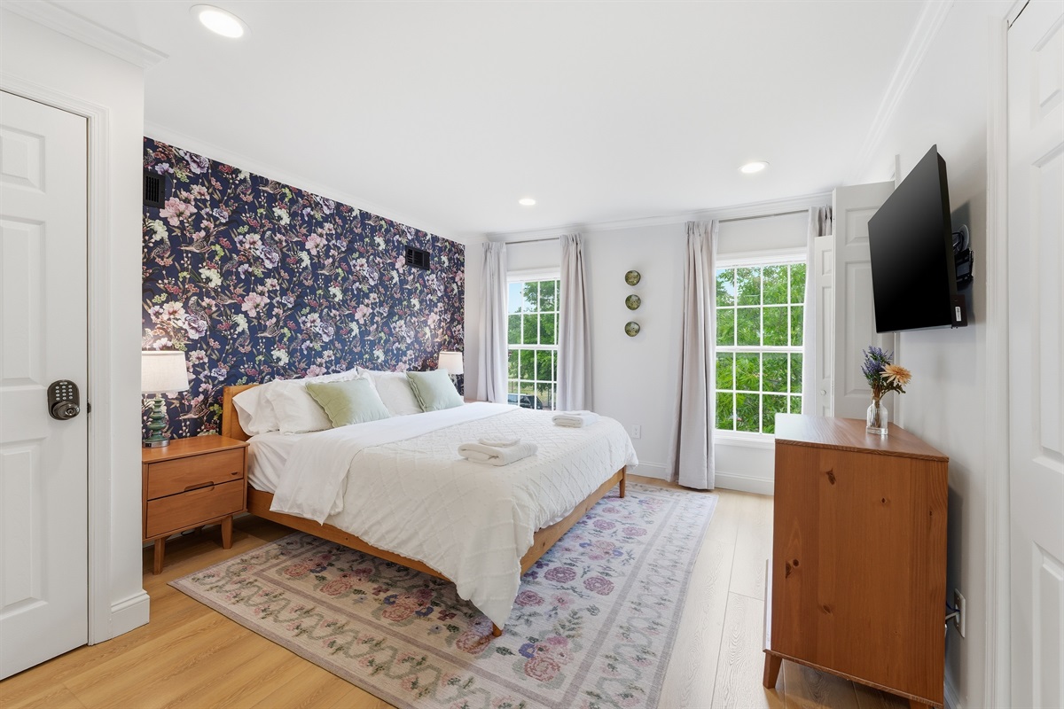 Bright and airy bedroom with plush bedding, calming tones, and boutique-inspired finishes throughout