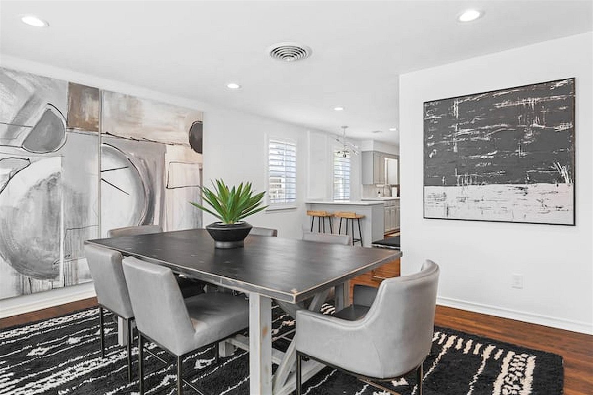Modern dining area with comfortable seating, contemporary artwork, and an open layout perfect for shared meals, conversation, and gathering together. ✨🍽️