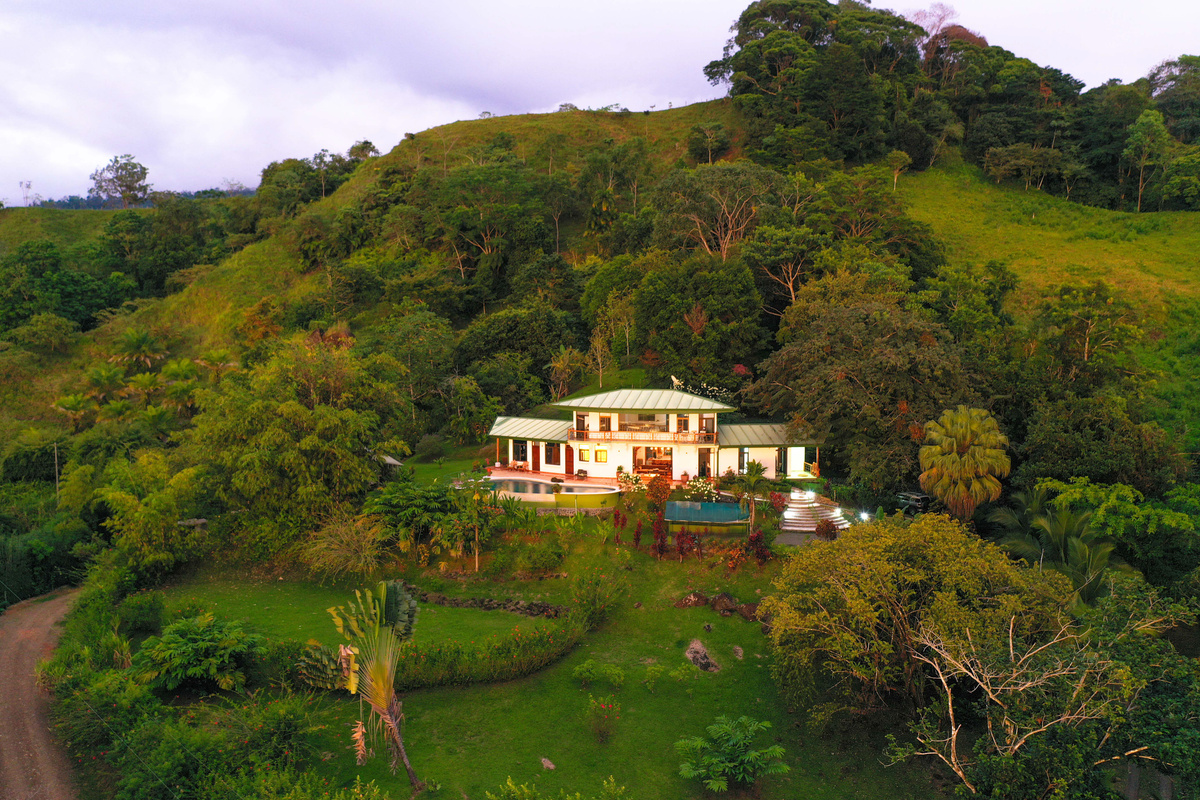 Aerial view of Casa Infinity — hilltop villa, infinity pool, and jungle setting in the Hills of Portalón