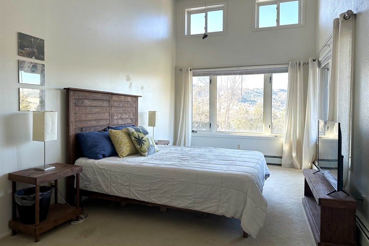 Our favorite feature of the end-of-the-hall queen room is the large windows and big views, but the overhead fan, TV, and large walk-in closet are big sellings points, too! 