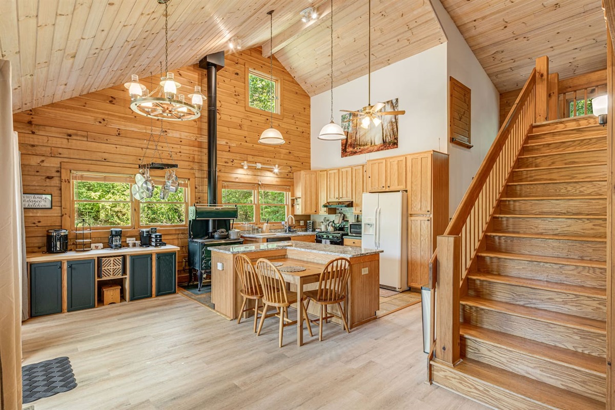 The heart of the home, this inviting kitchen is perfect for gathering, cooking, and sharing stories. Stairs are to the loft bedroom.