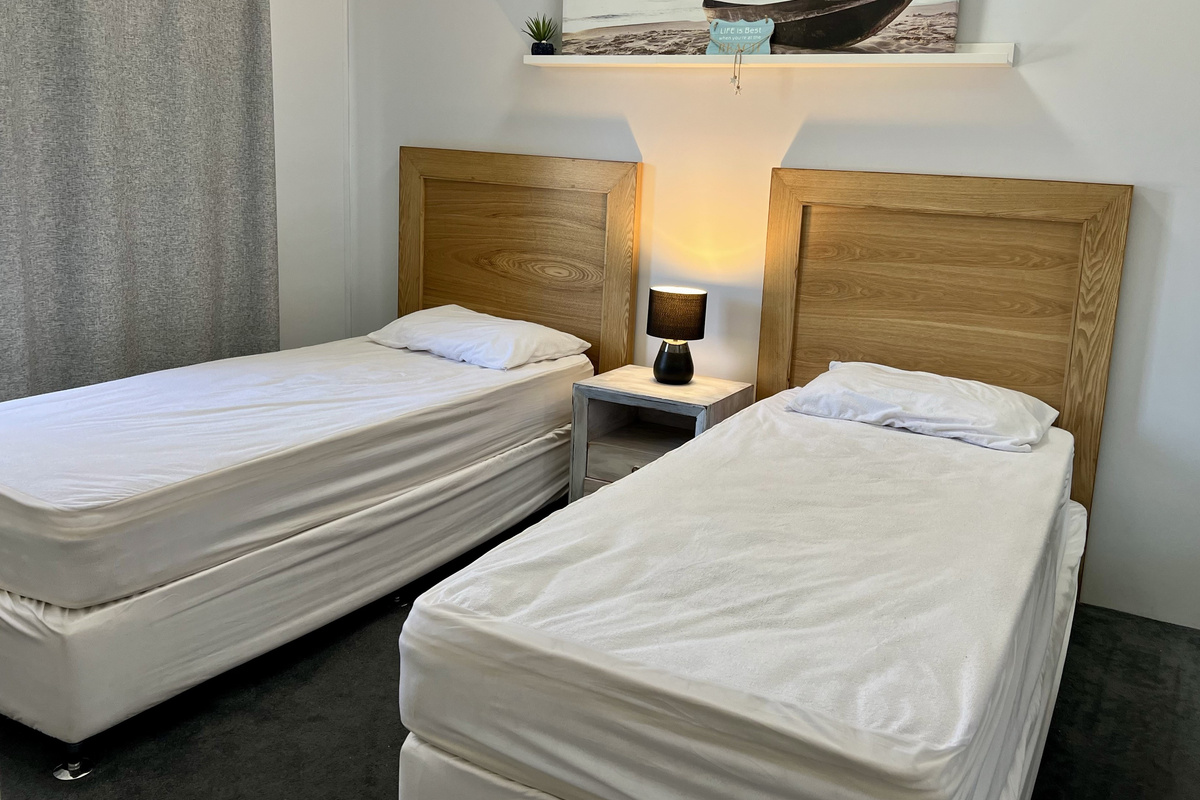 Bedroom Two with 2 single beds & built-in robe