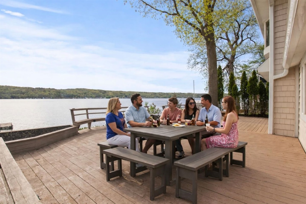 Spacious deck with ample seating and breathtaking lake views. Perfect for outdoor dining, gatherings, and enjoying the serene environment. Ideal for relaxation and taking in the beauty of nature.
