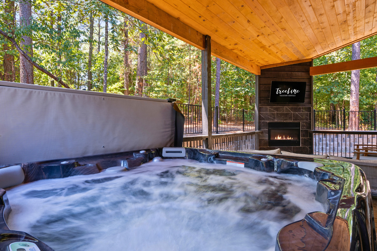 Soak in the bubbling hot tub while taking in the surrounding pines, with the covered setting making this a relaxing spot to enjoy throughout your stay.