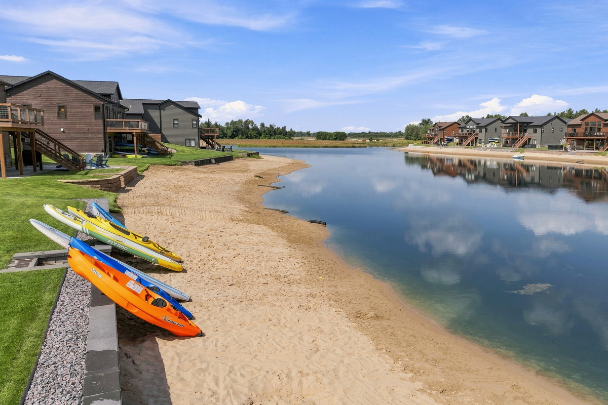 back lake area with kayaks and paddle boards for your stay