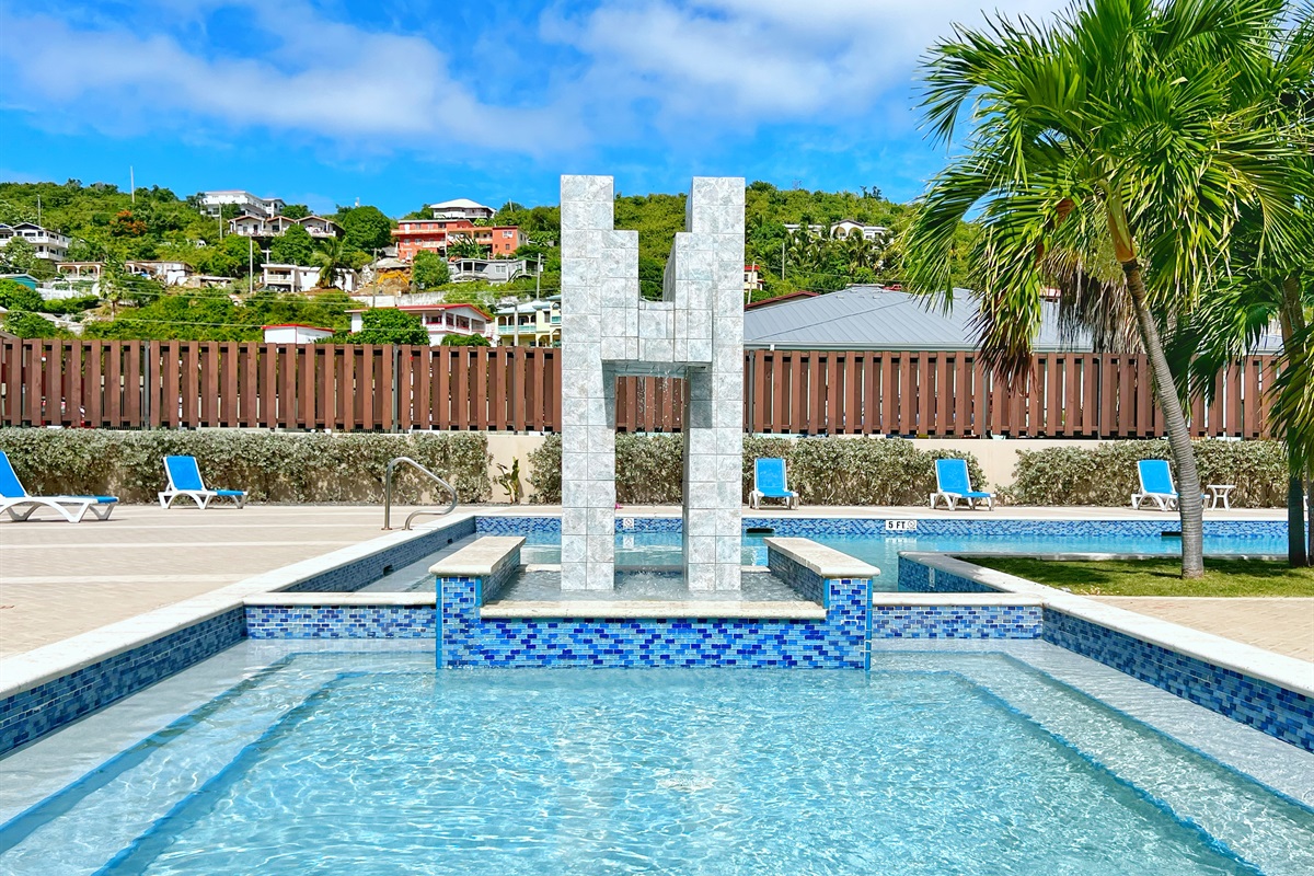 Palm-fringed pool area designed for sunny relaxation.