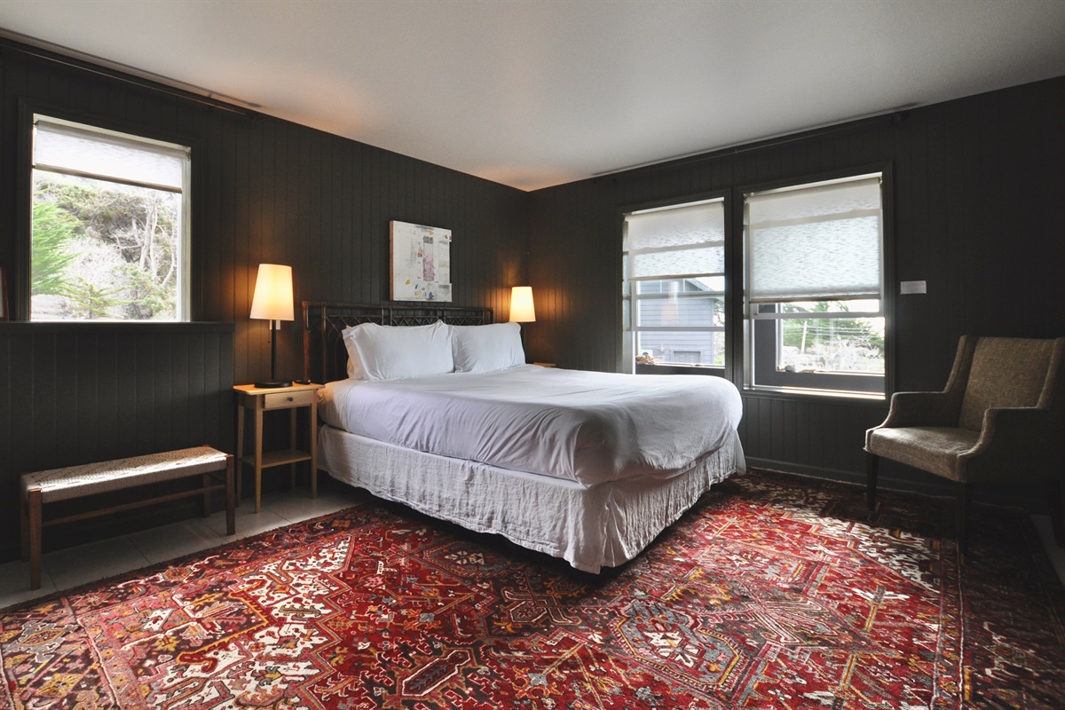 Downstairs bedroom: king bed, ocean views, smart TV, en suite bathroom with walk-in shower.