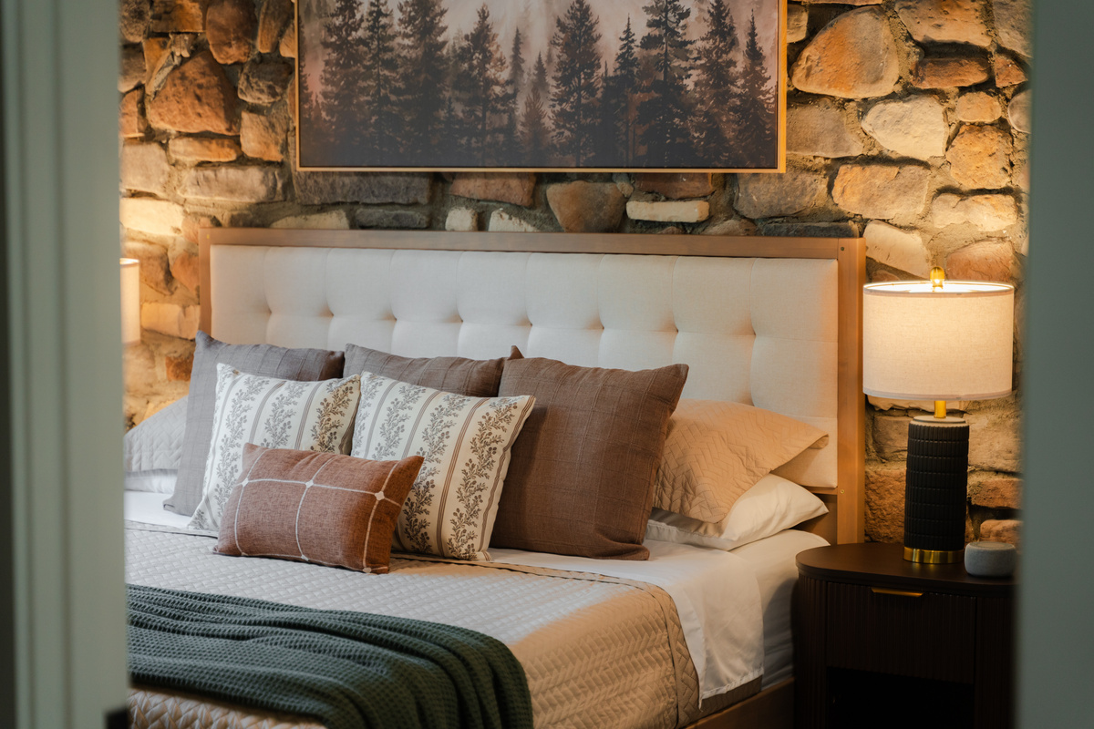 Unwind in a king bed featuring a beautiful stone accent wall