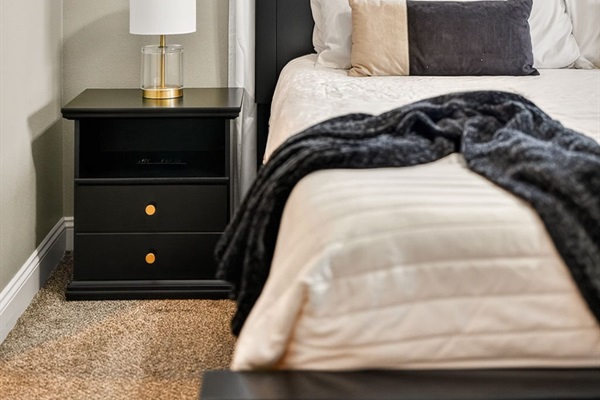 Layered bedding and throw blanket create a restful, inviting atmosphere.