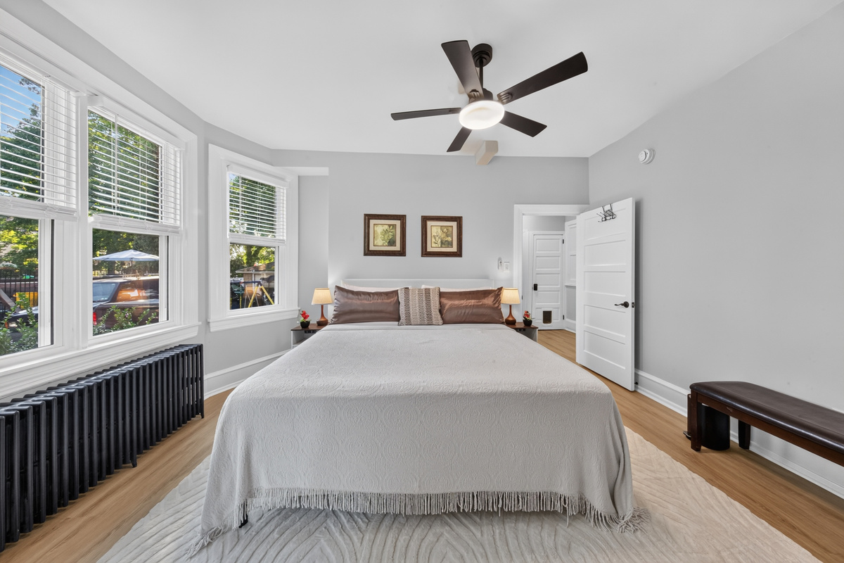 Spacious retreat featuring a comfortable King bed, room-darkening shades, and ceiling fan.
