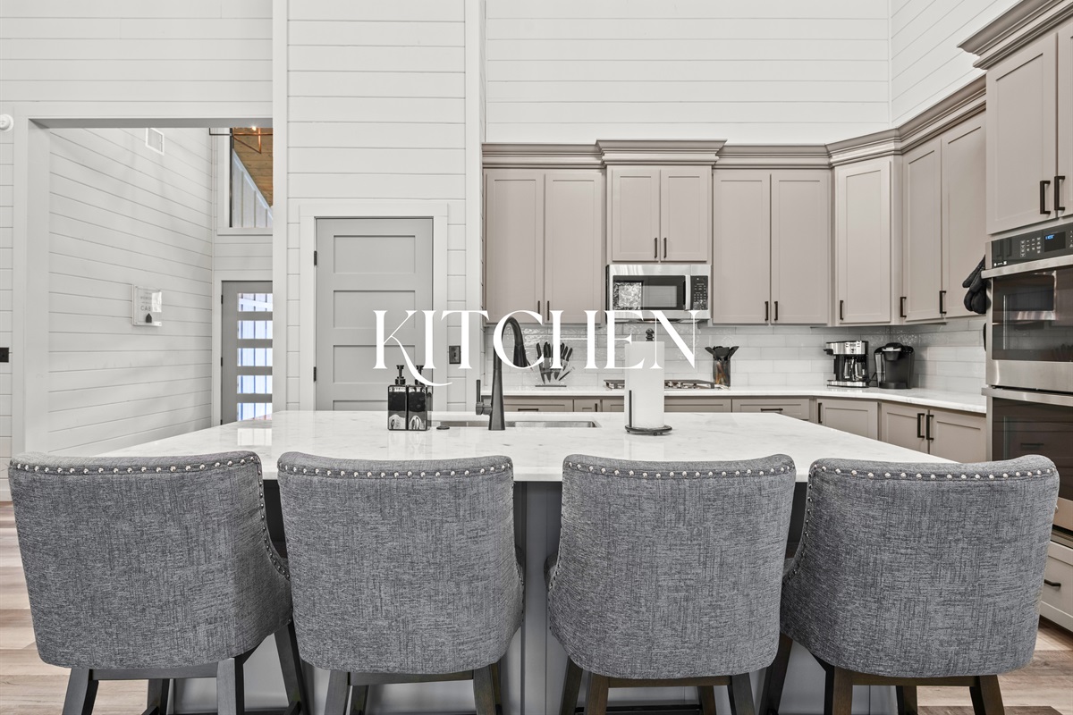 The kitchen’s sleek design and generous island make cooking for a crowd both easy and enjoyable.