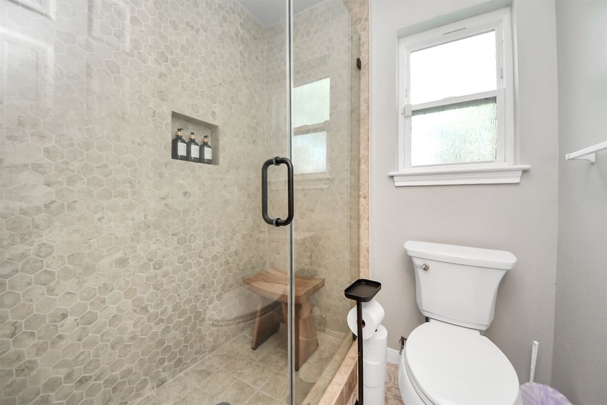 Shower and toilet room in guest bathroom.