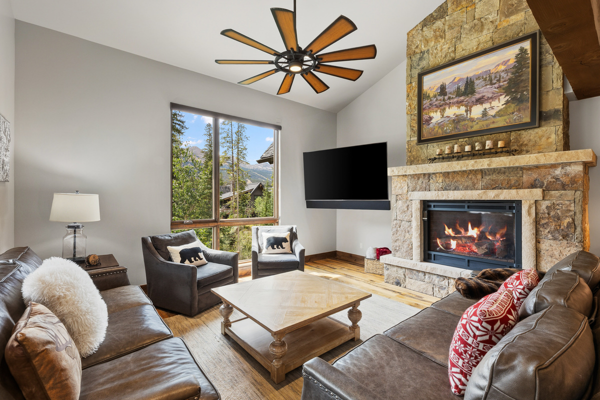Main living area with gas fireplace and mountain views