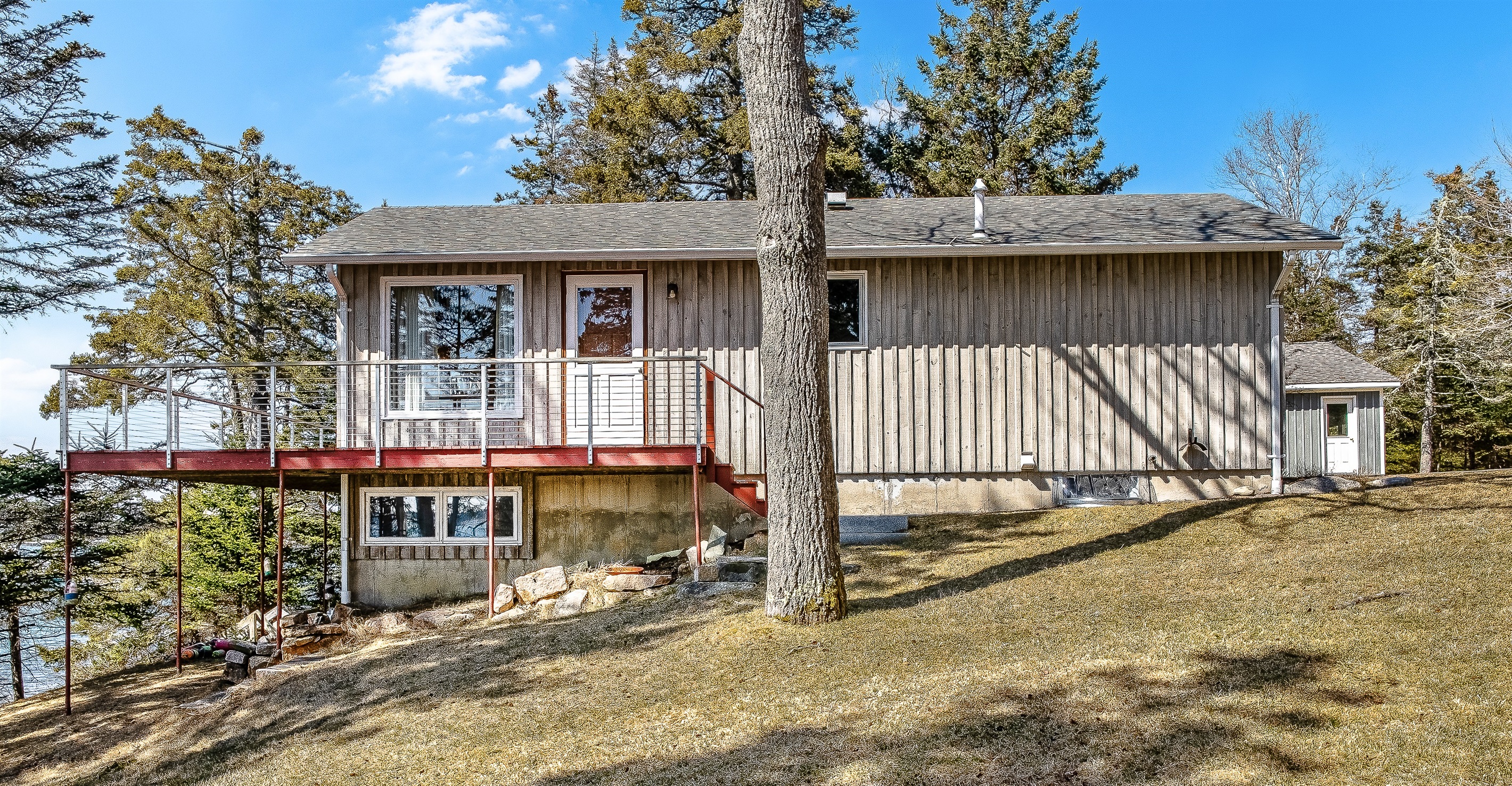 "Space to Spread Out."
The expansive, wrap-around yard provides a rare level of privacy for the 'Quiet Side.' From this angle, you can see the distinct separation between the upper viewing deck and the lower-level garden suite.