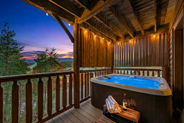 Your evening starts here — covered hot tub, Smoky Mountain sunset, and nowhere else you need to be. Pool towels provided for every guest.