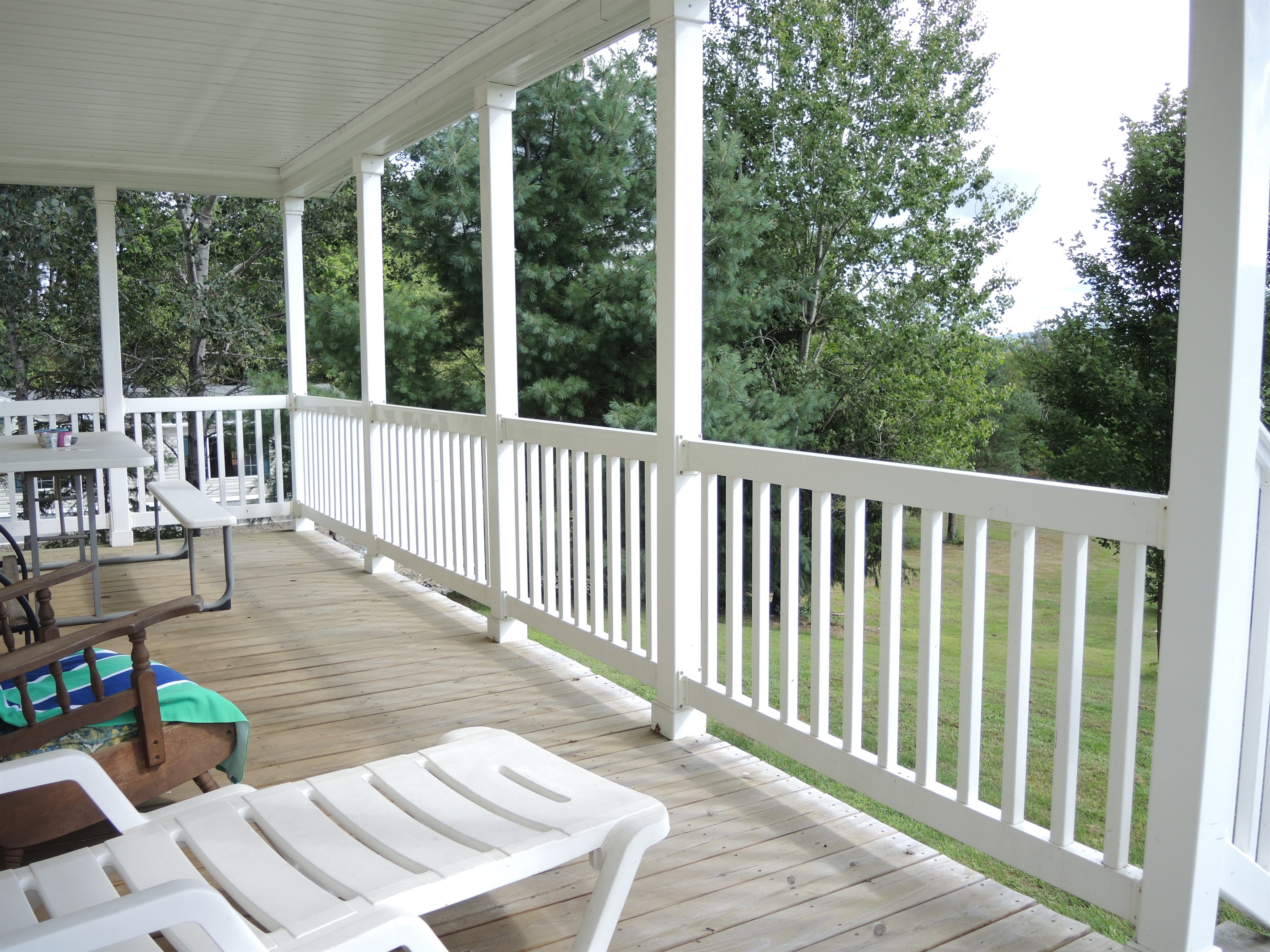 Covered porch overlooking the back lawn