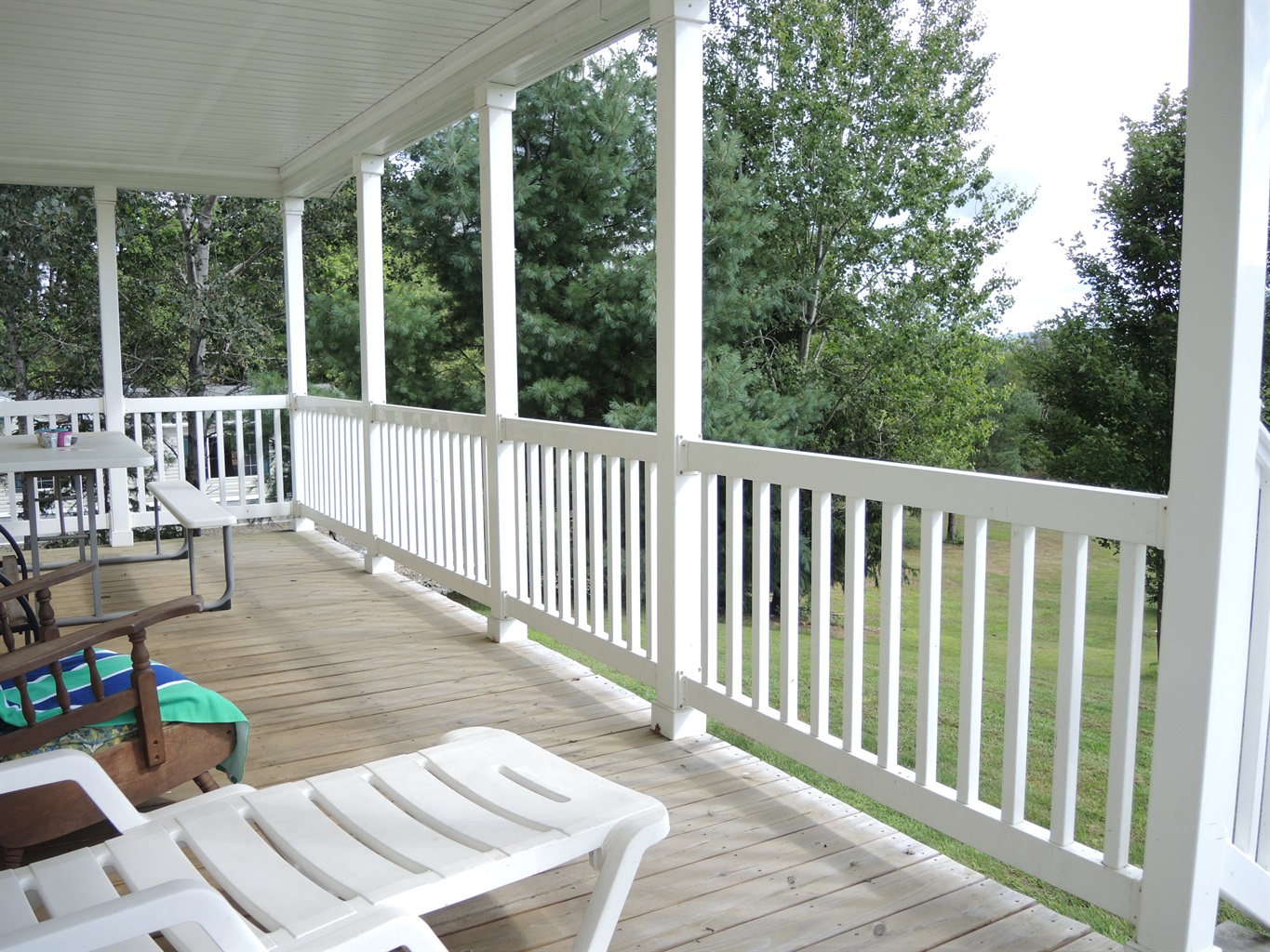 Covered porch overlooking the back lawn