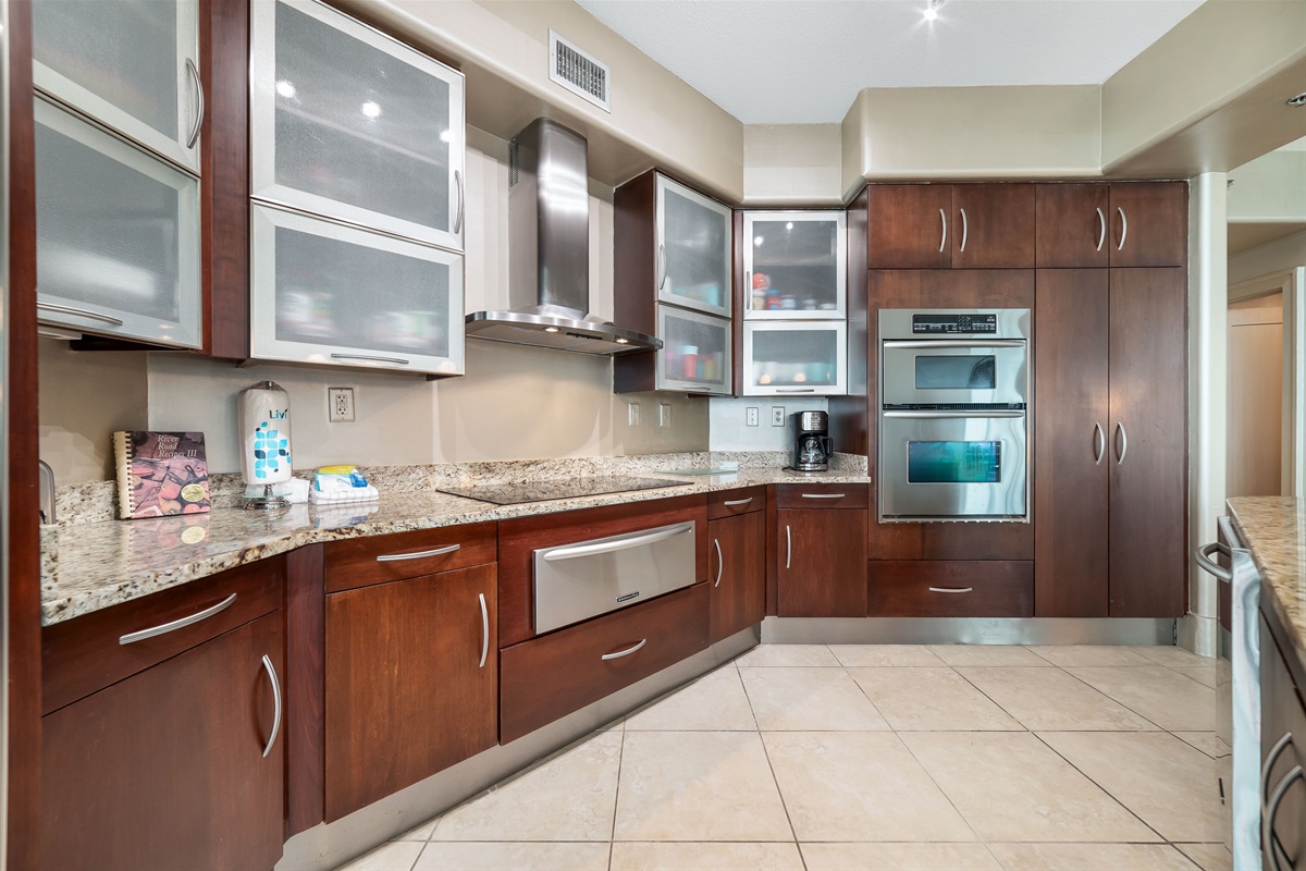 This well-designed kitchen boasts rich wood cabinetry, granite countertops, and stainless steel accents. The open layout ensures a seamless transition to the living and dining areas, creating a perfect space for gatherings.