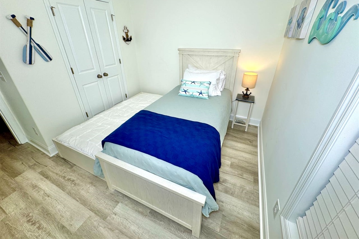 Twin trundle bed with blackout curtains. Linens for bottom twin trundle bed in closet. 