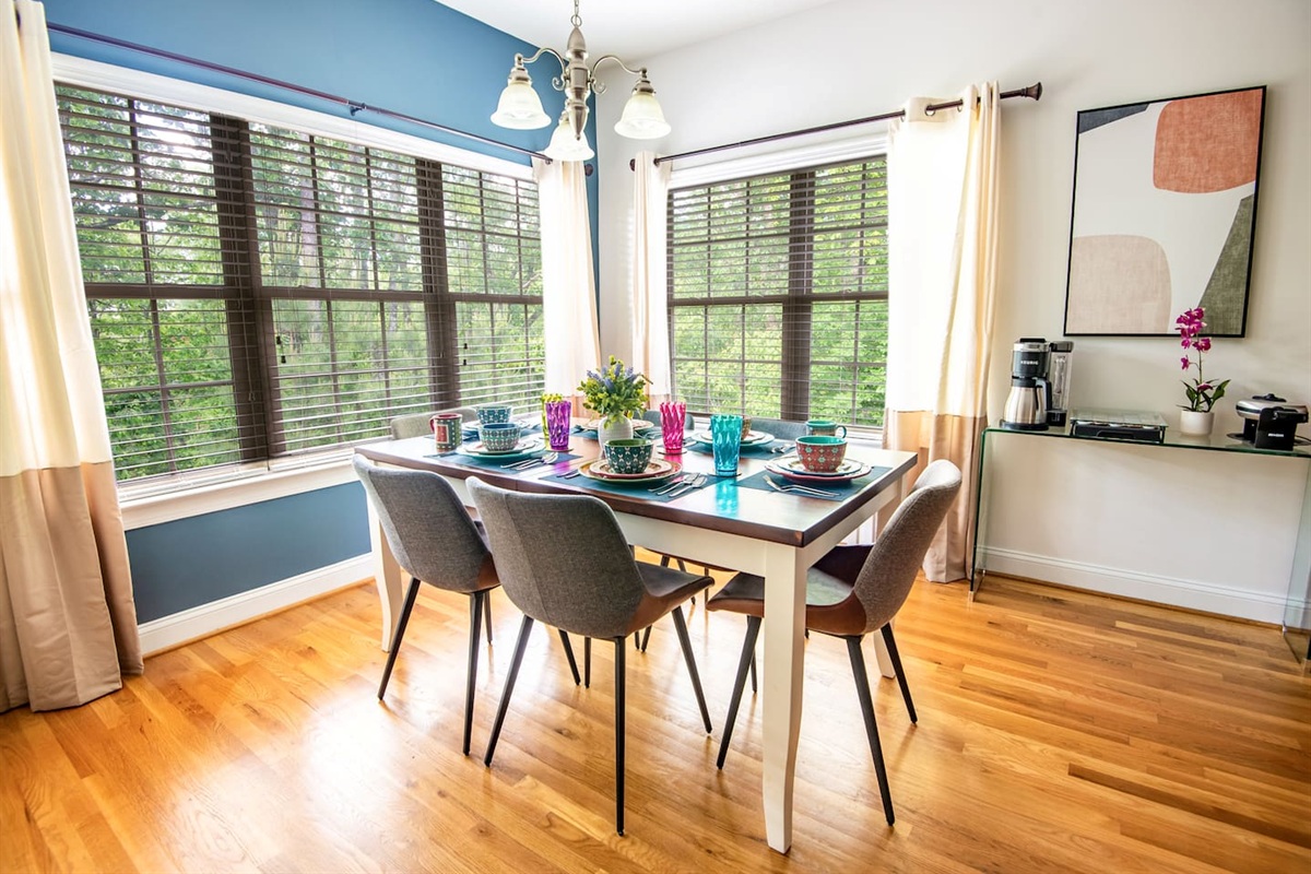 Large dining area with seating for 8 (expands to 8) and beautiful background of the woods and backyard putting green with Azalea bushes.
