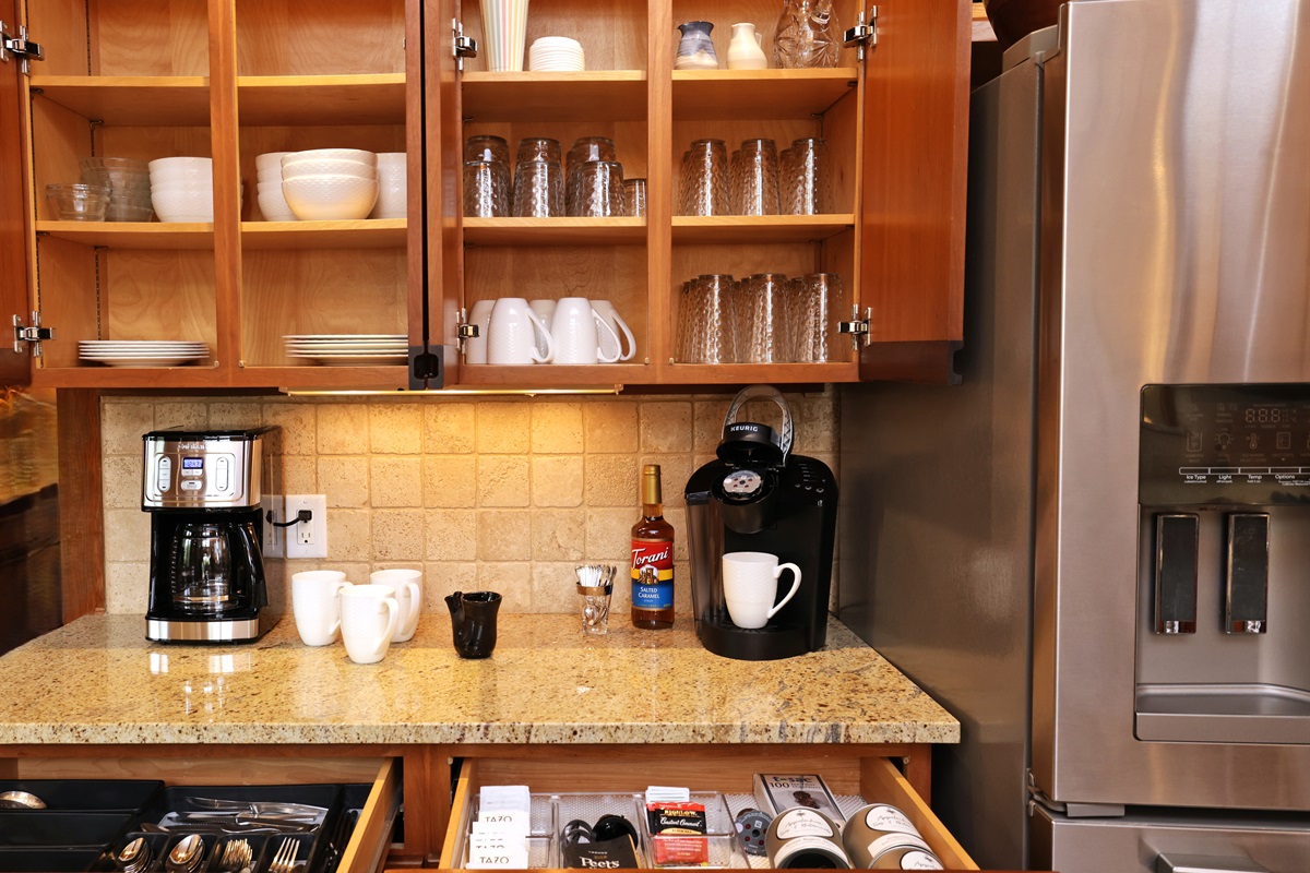 Coffee and tea bar area with a drawer of tea selections and sweeteners plus Peets Coffee to start out your stay!  Dishes are stored above with 16 place settings (they are set up on dining table when this photo was taken!)