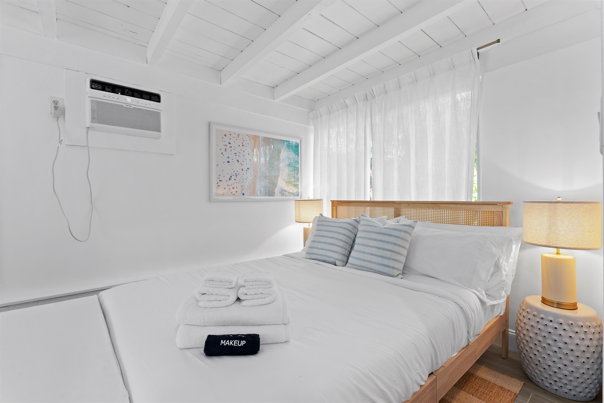 Cozy queen bedroom with soft coastal tones and a peaceful, airy feel.
