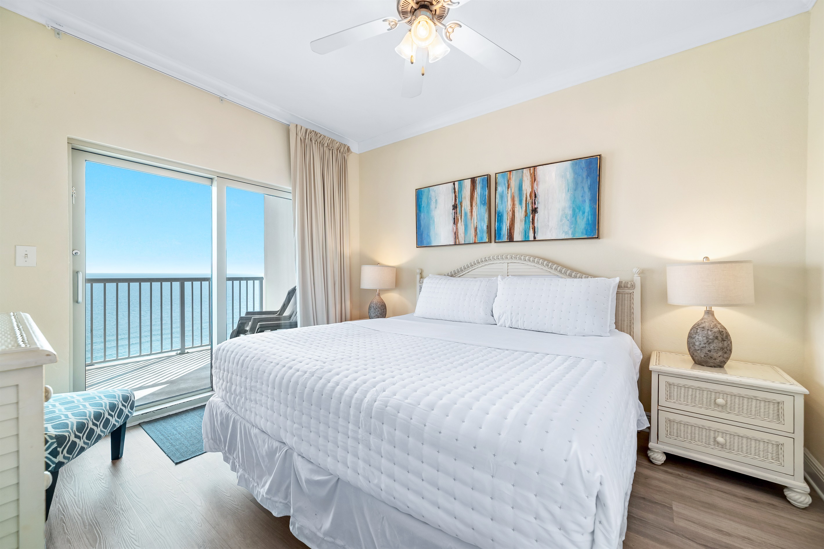 Enjoy the perfect blend of comfort and coastal beauty in this inviting primary bedroom with direct balcony access and stunning ocean views.