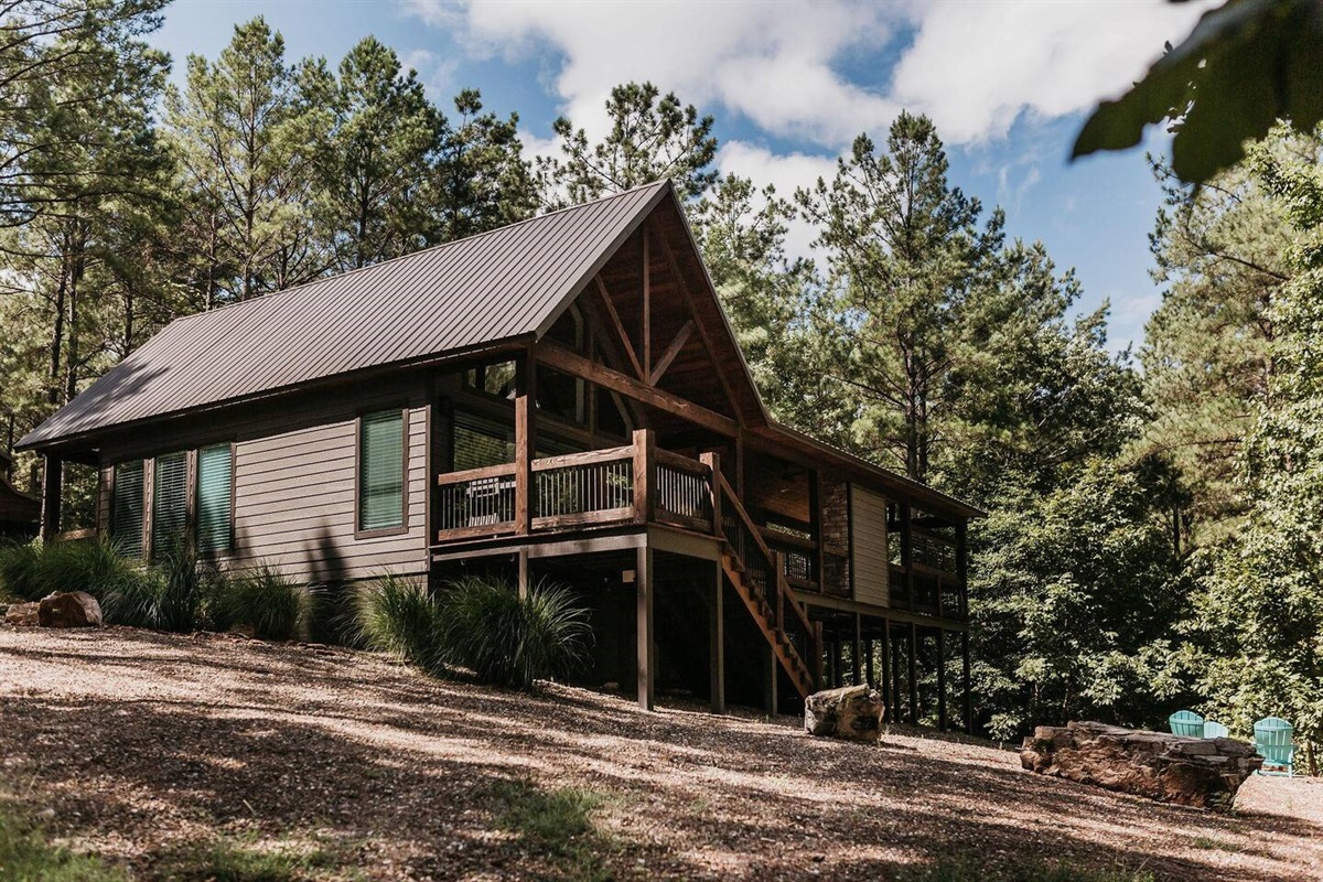 Exterior Retreat: Embrace nature with this stunning cabin nestled among towering pines!