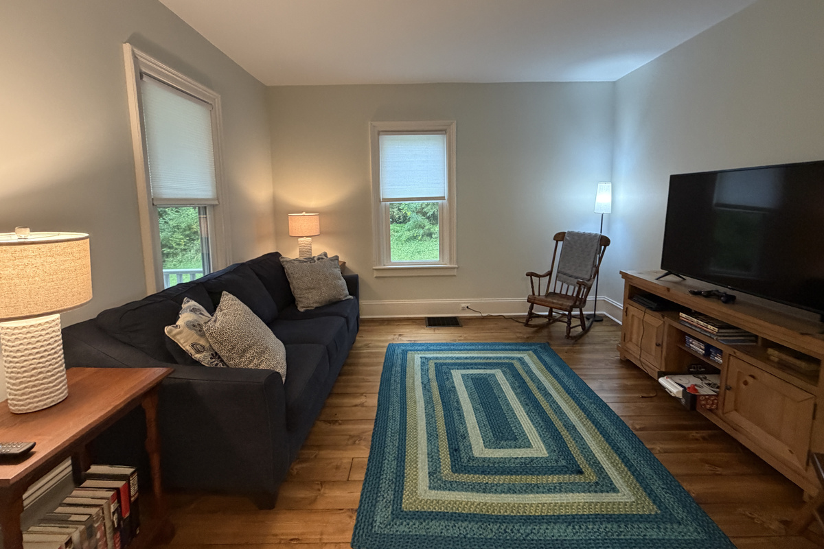 Living room with SmartTV and assorted games and books