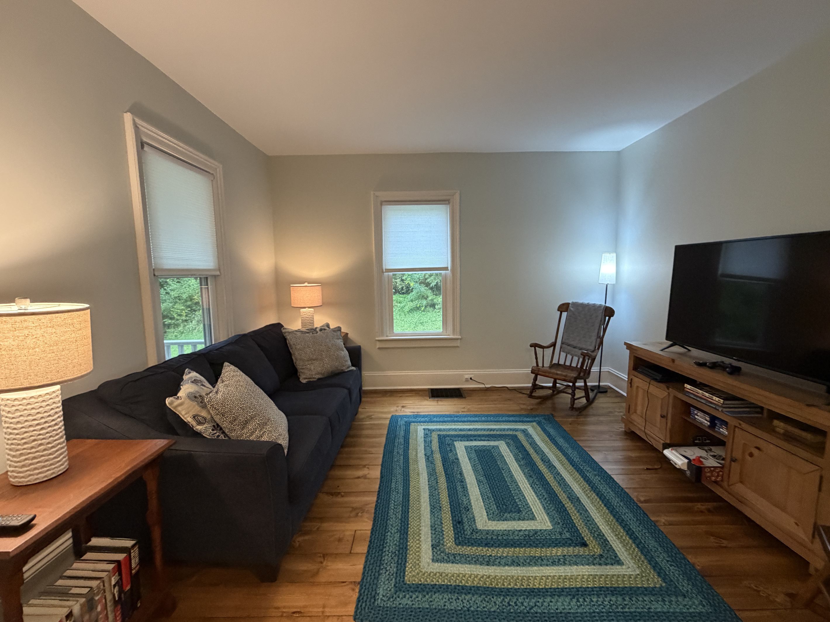 Living room with SmartTV and assorted games and books