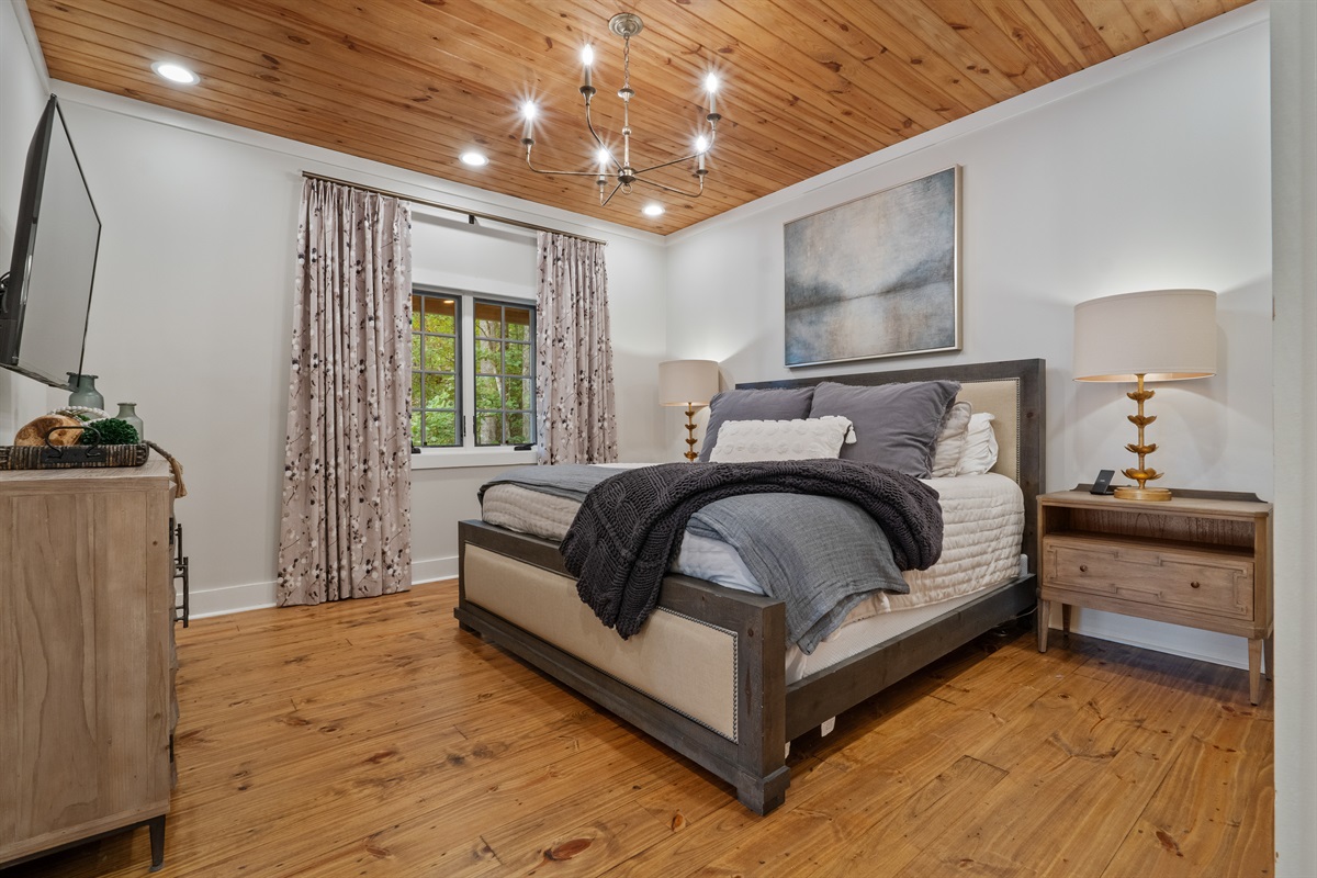 Relax in the master suite with premium bedding, offering a comfortable retreat for rest and relaxation after a day on the lake.