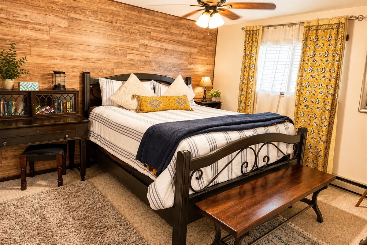 This bedroom is on the 1st floor and has a king size bed, night stands with reading lights on both sides, a closet, Tv with cable, small desk and baseboard heaters.  There is mattress topper on this bed making it SUPER comfy.