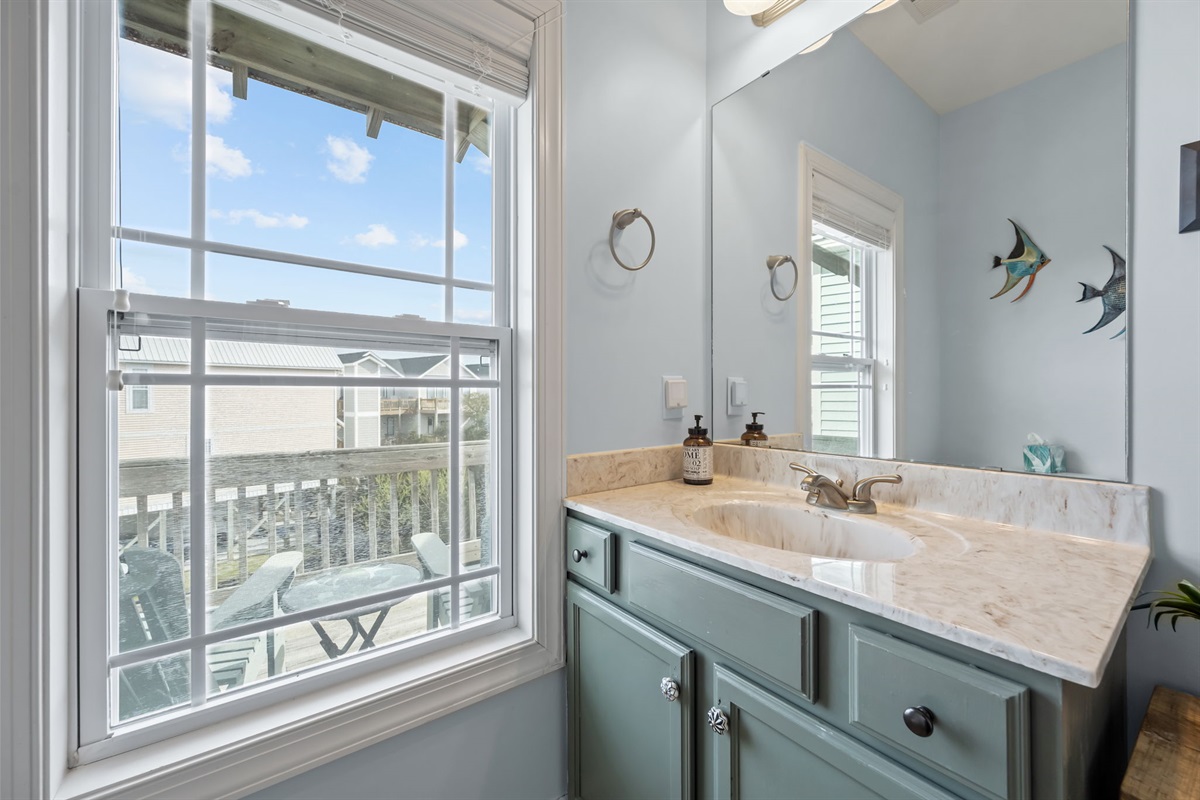 Upstairs bathroom with natural light and vanity with plenty of storage