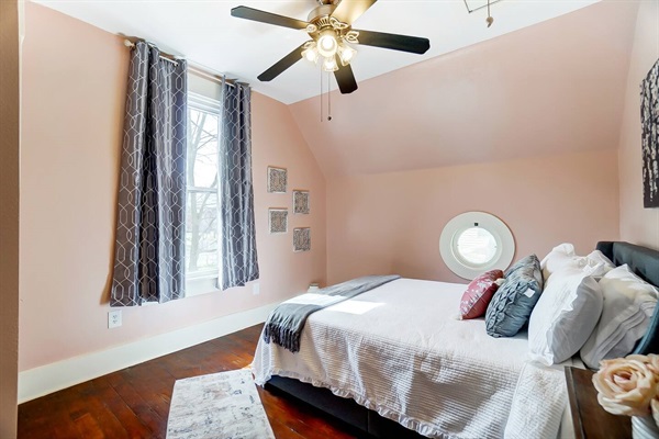 The queen bedroom on the second floor showcases the "peephole" windows that were popular in the 1920's when this house was built.
