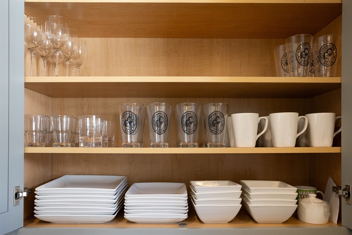 Cabinets are fully stocked with stylish drinkware for every beverage, from water to wine.