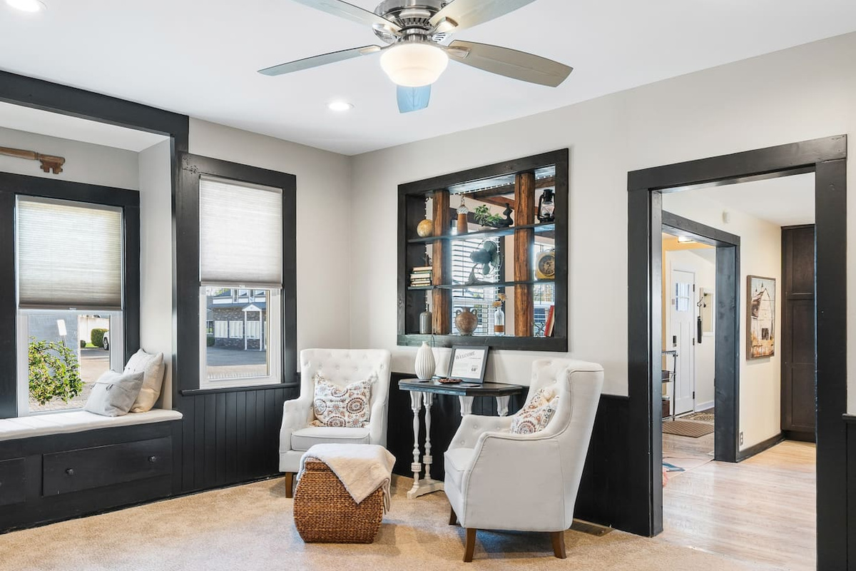 Main-floor sitting room with comfortable seating and easy access to the surrounding rooms.