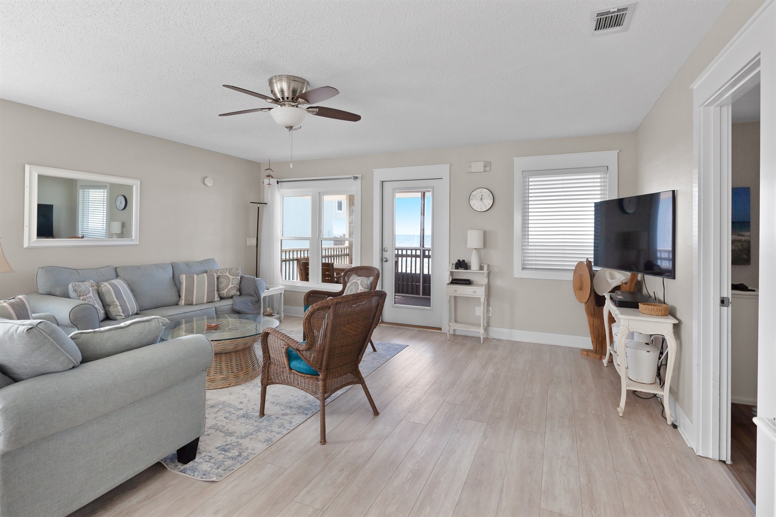 Bright, open living room with panoramic Gulf views - the perfect place to gather with family, unwind after a beach day, or simply enjoy the beauty of Cape San Blas from the comfort of the home