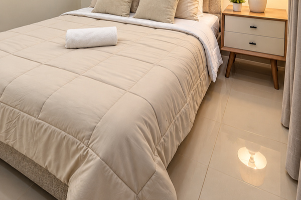 Cozy second bedroom with a queen bed, A/C, warm ambient lighting, and a closet with built-in drawers for storage. 🛏️✨