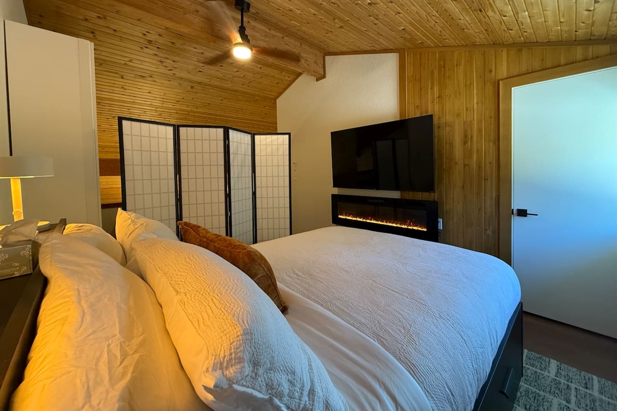 Loft Bedroom Privacy: The loft bedroom, shown with the privacy screens, fireplace and 65" smart TV. 