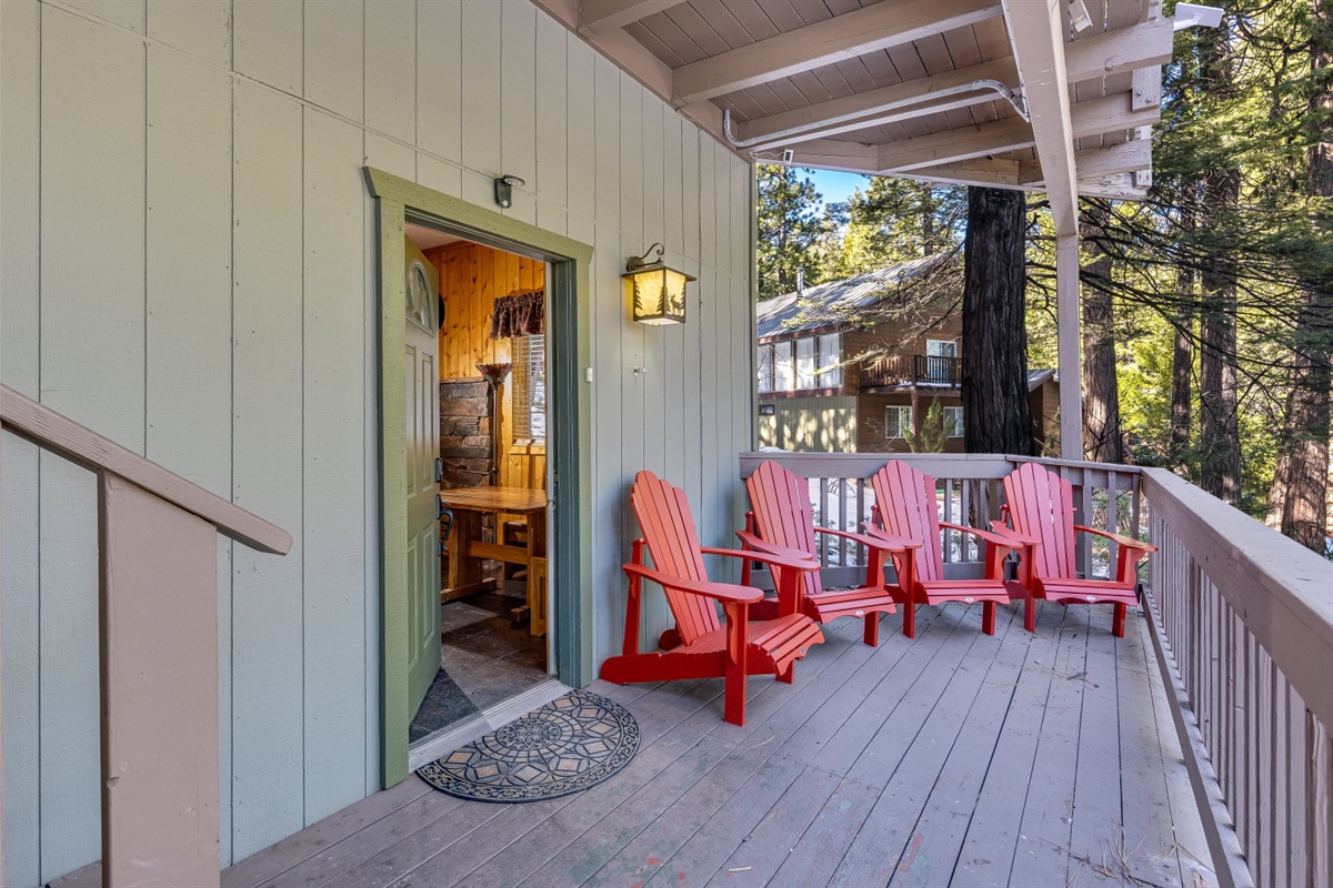Inviting front entrance with a deck adorned with Adirondack chairs, offering a perfect spot to relax. 