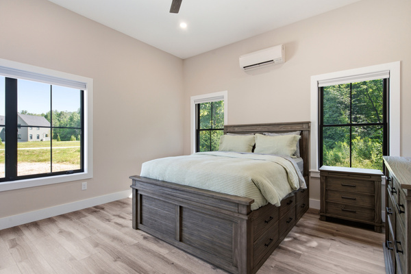 A bright and peaceful retreat with comfortable bedding and relaxing views outside.