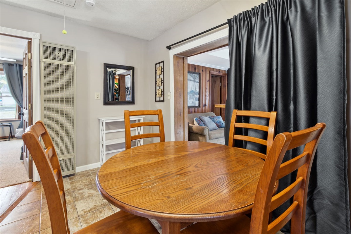 Dining room table offers extra leaf's to allow for more people. Extra seats located in sunroom. Shelving unit allows for groceries or storage. Door seen in laundry is our locked supply closet, which isn't available for use.