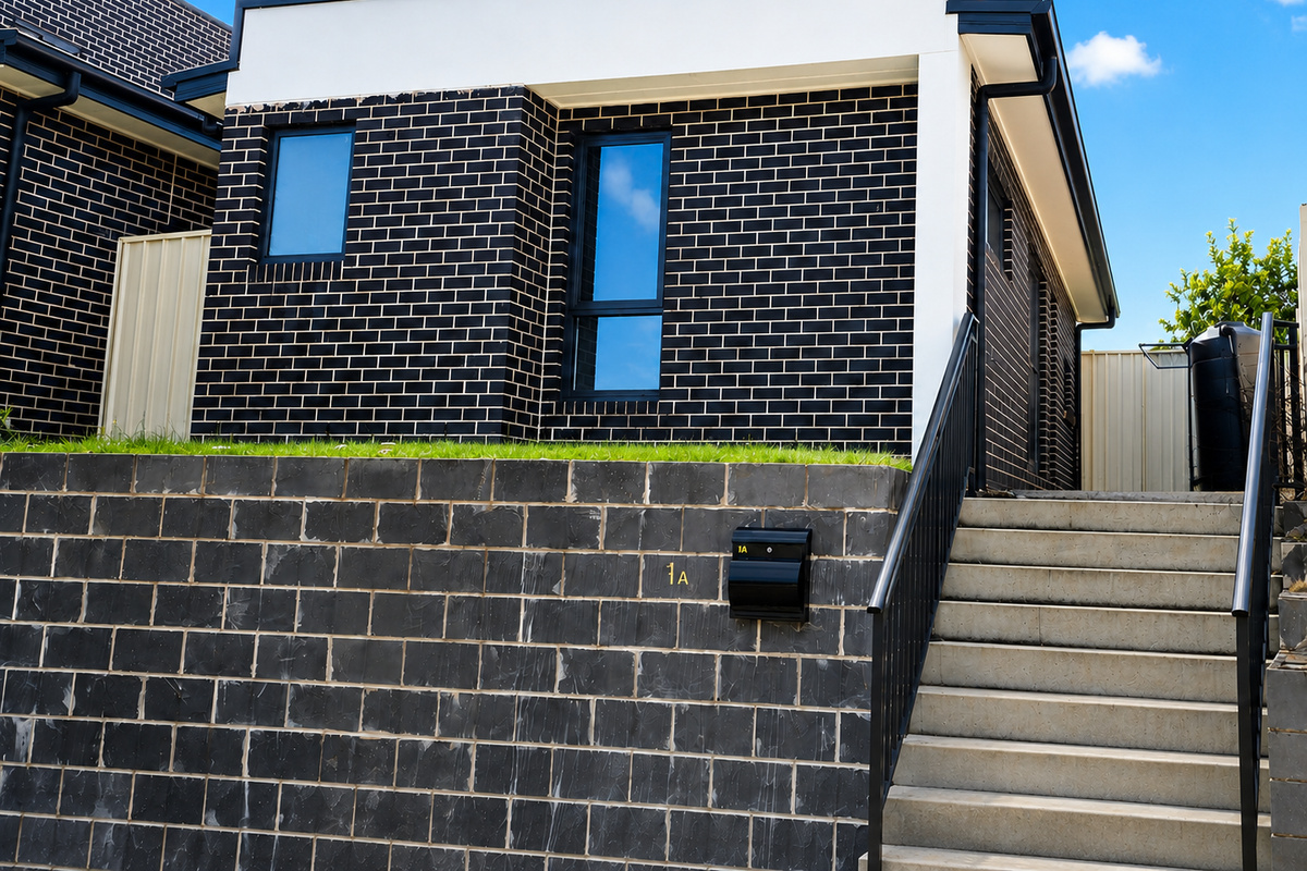The exterior steps lead up beside the marked 1A letterbox, giving a clear view of the front access point.